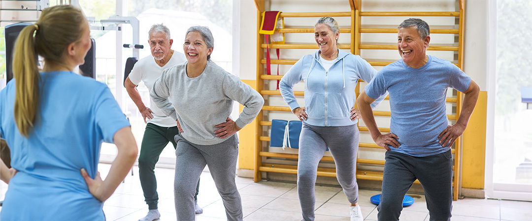 A group of elderly people in a fitness class